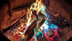 campfire with blue, green, red and, yellow and orange colored flames