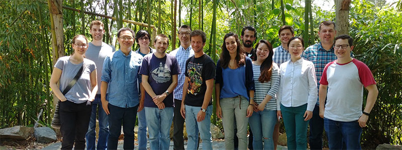 Hahn lab group photo in front of trees for a birthday lunch in 2018.